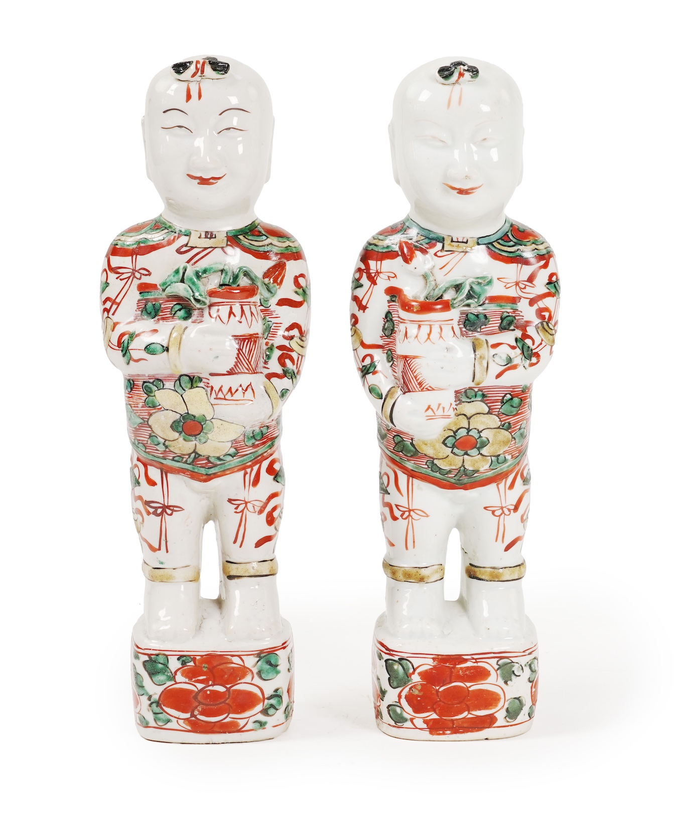 A pair of Chinese famille verte figures of smiling boys, Kangxi period
